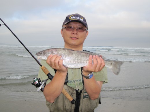 Man with his catch after surf fishing