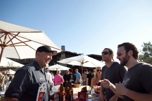 Beer Garden attendees talking to a brewer during San Diego Beer Week Beer Garden