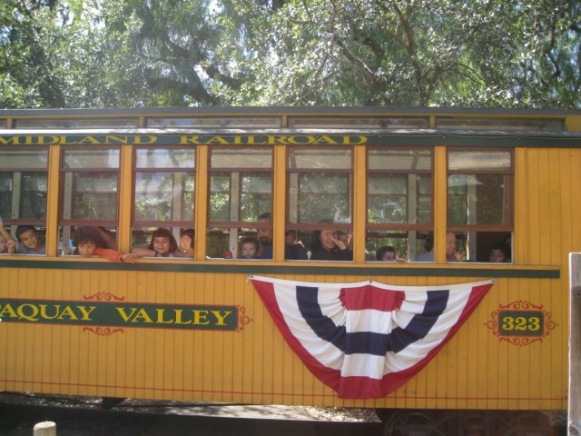 My daughter rides the rails at a train-themed birthday party at Old Poway Park.