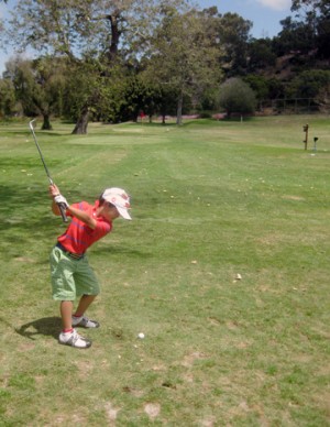 A young golfer tees off on the 39-yard first hole at Presidio Park.