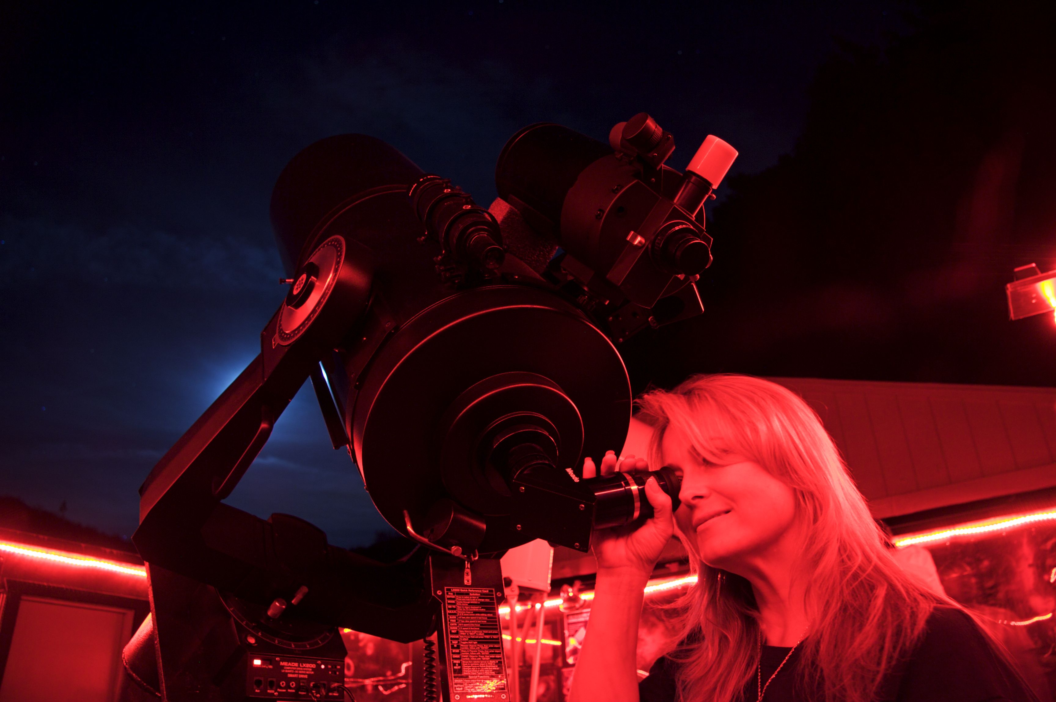 Woman Looking Through a Telescope