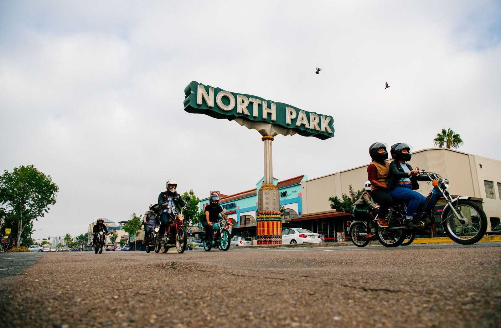 Moped riding past the North Park sign - Top Things to Do in San Diego