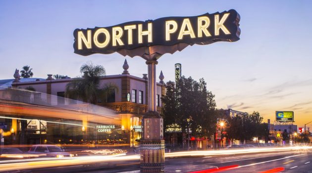 The North Park neighborhood sign in San Diego is depicted at dusk.